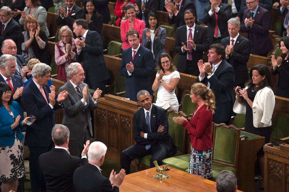 President Barack Obama receives a standing ovation in the House of Commons on Parliament Hill in Ottawa, Canada, June 29, 2016. (Photo by Adrian Wyld/The Canadian Press/AP)