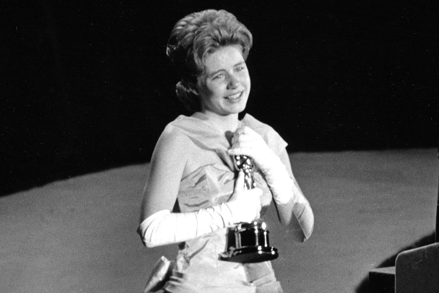 In this April 8, 1963 file photo, actress Patty Duke, 16, accepts the Oscar as best supporting actress for her work in 