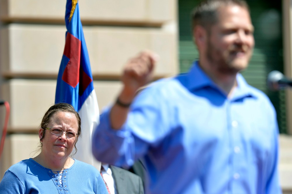 Rowan County Clerk Kim Davis, left, listens as Casey County Clerk Casey Davis speaks to a group of supporters during a rally at the Kentucky State Capitol in Frankfort Ky., Saturday, Aug. 22, 2015. (Photo by Timothy D. Easley/AP)