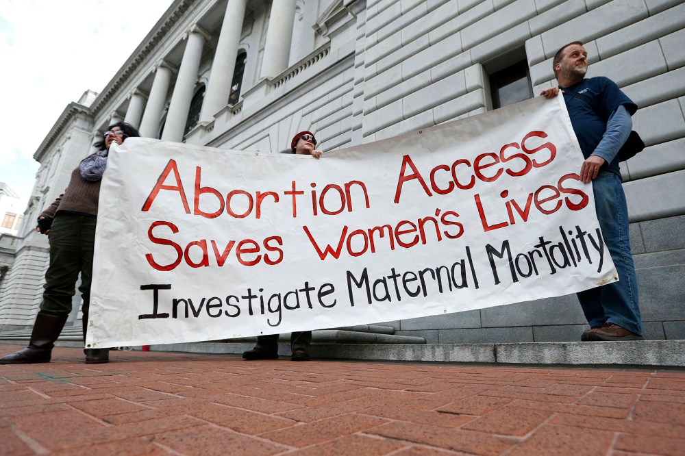 Bill Lambert, right, Phil Walk, center, and Brenda Serrato demonstrate outside of the 5th U.S. Circuit Court of Appeals Wednesday, Jan. 7, 2015, in New Orleans. (Photo by Jonathan Bachman/AP)