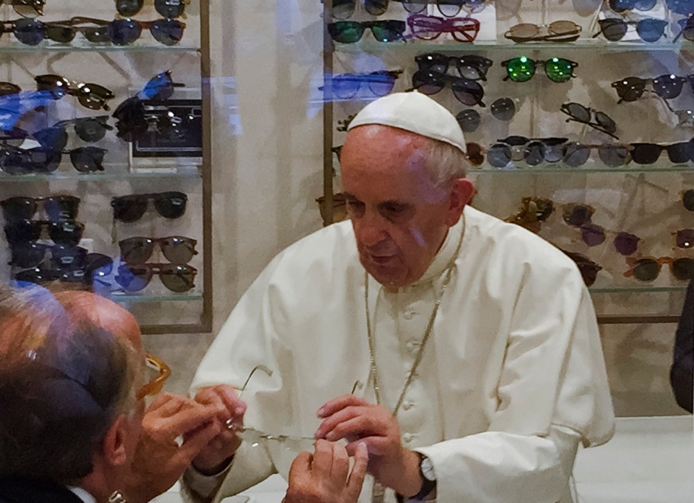 Pope Francis tries on a pair of spectacles in an eyeglass store in via del Babuino, in central Rome, Italy on Sept. 3, 2015. (Photo by Daniel Soehne/AP)