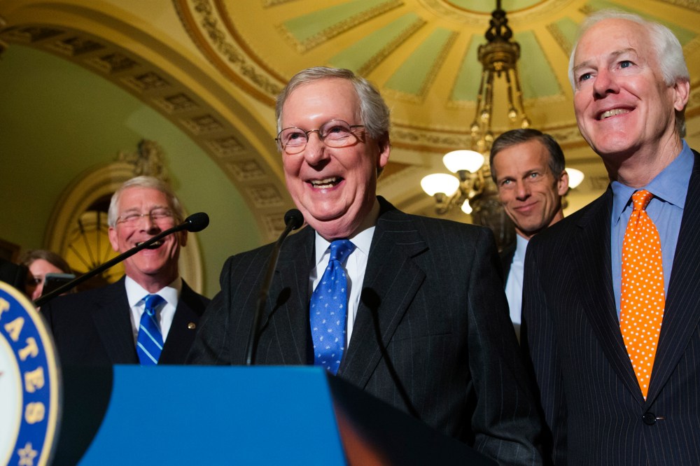 Senate Majority Leader Mitch McConnell, R-Ky., smiles as he speaks with reporters following a closed-door policy meeting on Capitol Hill in Washington, Feb. 23, 2016. (Photo by J. Scott Applewhite/AP)