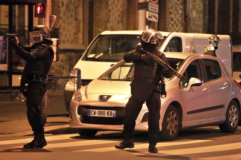 Police officers take up positions in Saint Denis, a northern suburb of Paris, Nov. 18, 2015. (Photo by Thibault Camus/AP)