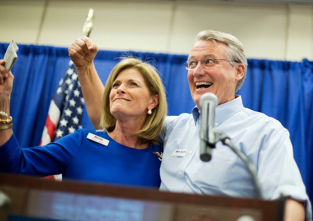 Georgia Republican U.S. Congressman Rick Allen, cheers with wife Bettie at a campaign event for Georgia Republican U.S. Senate candidate David Perdue, Wednesday, Oct. 29, 2014, in Augusta, Ga.