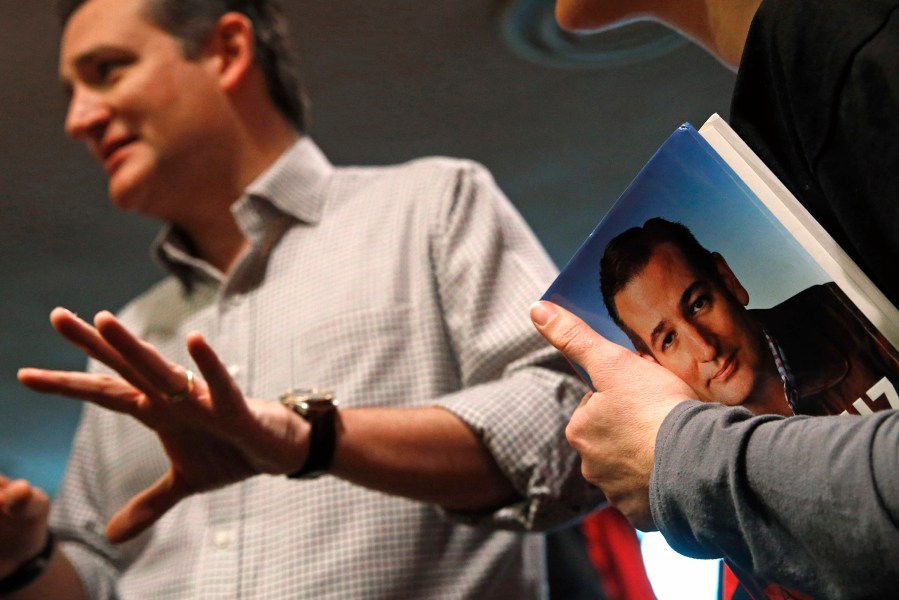 A woman patiently awaits Ted Cruz' signature at a town hall at Praise Community Church in Mason City, Iowa, Jan. 8, 2016. (Photo by Patrick Semansky/AP)