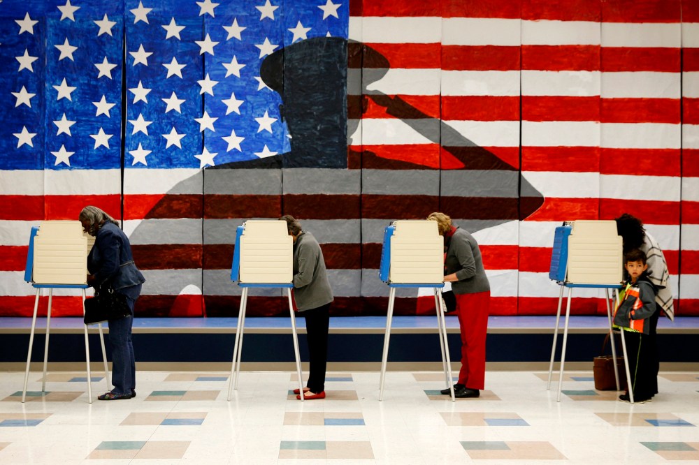 Voters line up in voting booths to cast their ballots at Robious Elementary School in Chesterfield, Va. on Nov. 8, 2016. (Photo by Shelby Lum/Richmond Times-Dispatch/AP)