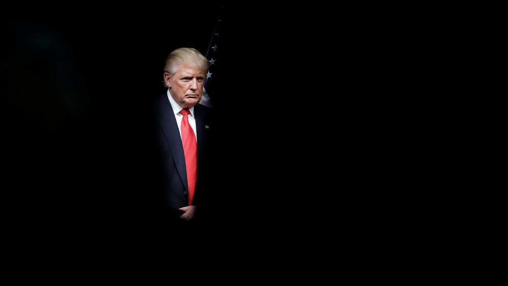 Republican presidential candidate Donald Trump is seen through the audience before participating in a roundtable event, Sept. 27, 2016, in Miami. (Photo by John Locher/AP)