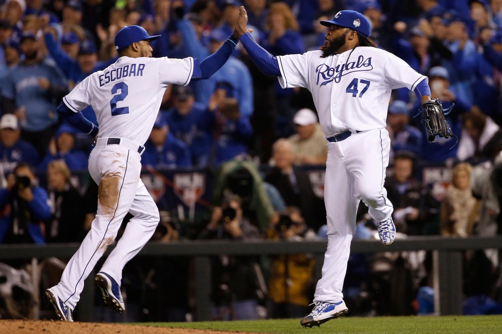 Kansas City Royals pitcher Johnny Cueto (47) celebrates with Alcides Escobar during Game 2 of the Major League Baseball World Series against the New York Mets, Oct. 28, 2015, in Kansas City, Mo. (Photo by Matt Slocum/AP)