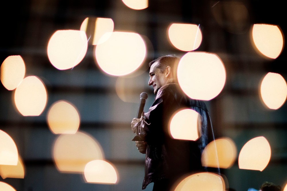 Republican presidential candidate, Sen. Ted Cruz, R-Texas, is seen through Christmas lights as he speaks during a campaign event, Dec. 18, 2015, in Kennesaw, Ga. (Photo by David Goldman/AP)