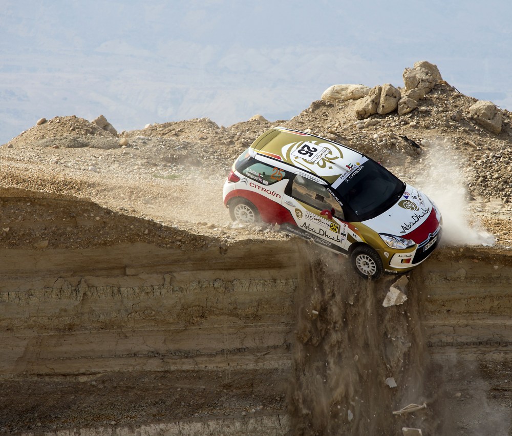 A car veers off a cliff during the first stage of the Jordan Rally in Sweimeh near the Dead Sea on May 10, 2013.