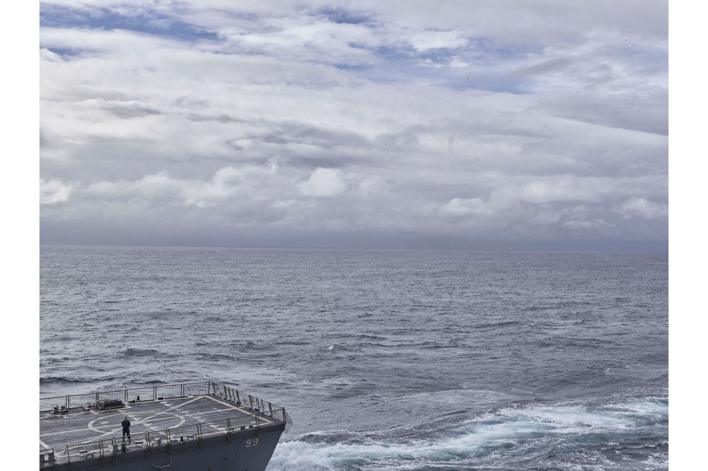 A U.S. Navy sailor stands on the deck of the USS Farragut as his ship approaches the USS Bataan to practice ‘UNREP’, or underway replenishment of cargo and fuel on May 24, 2016. (Photo by Balazs Gardi for MSNBC)