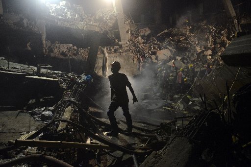 A worker leaves the site where a garment factory building collapsed near Dhaka, Bangladesh Monday, April 29, 2013. (AP Photo/Ismail Ferdous)