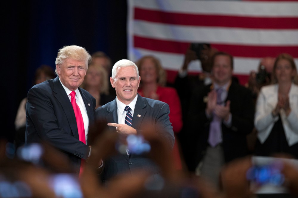 Republican presidential candidate Donald Trump, left, shakes hands with vice presidential candidate Gov. Mike Pence, R-Ind., during a town hall, July 25, 2016, in Roanoke, Va. (Photo by Evan Vucci/AP)