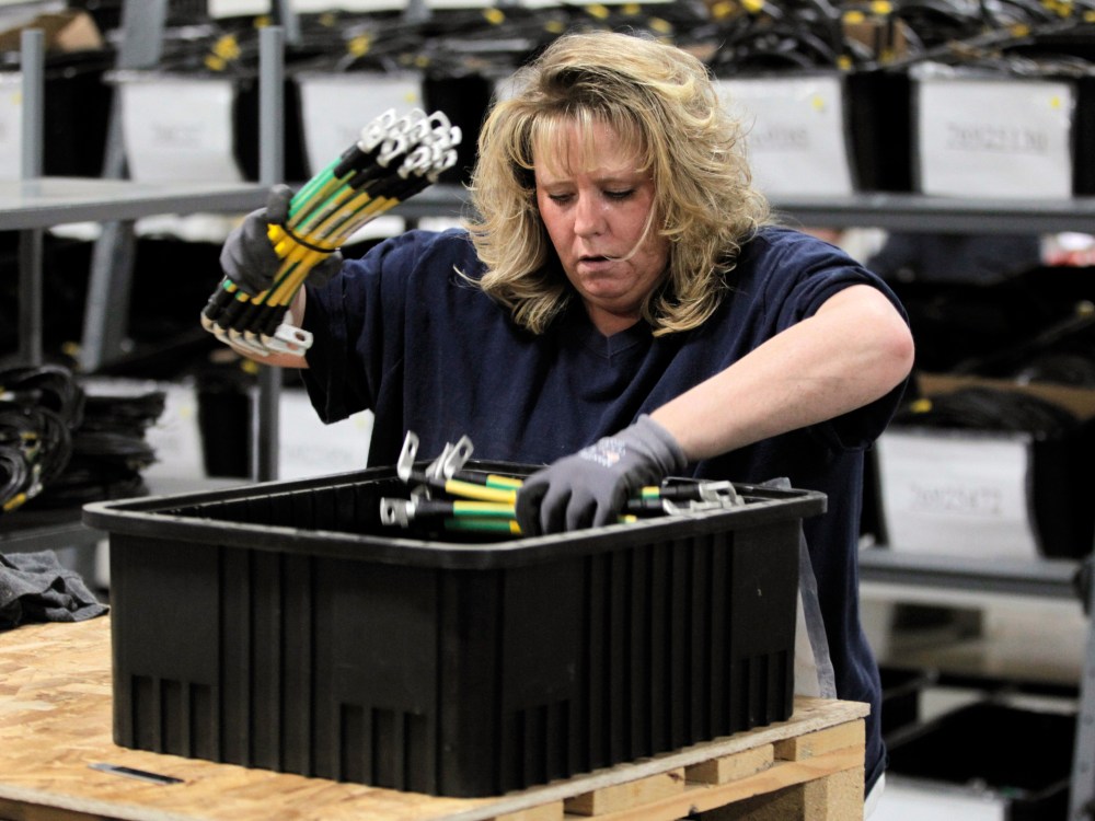 Renee Orriz sorts cables used in wind turbines, inside the production area at the Walker Components factory, in Denver. One-third of the workers at the factory have been laid off this year. Orders are down, and the wind energy boom touted by President...