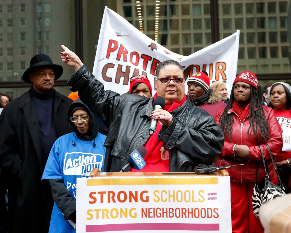Karen Lewis, center, President of the Chicago Teachers Union addresses other opponents of a plan to close 54 Chicago Public Schools during a demonstration and march through Chicago's downtown Wednesday, March 27, 2013. (AP Photo/Charles Rex Arbogast)