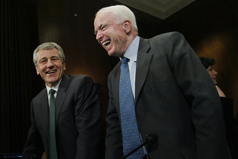 Chuck Hagel, center, R-Neb, and John McCain, right, R-Ariz, share a laugh on the Capitol Hill, Thursday, Feb. 12, 2004 in Washington. (Photo by Manuel Balce Ceneta/AP)