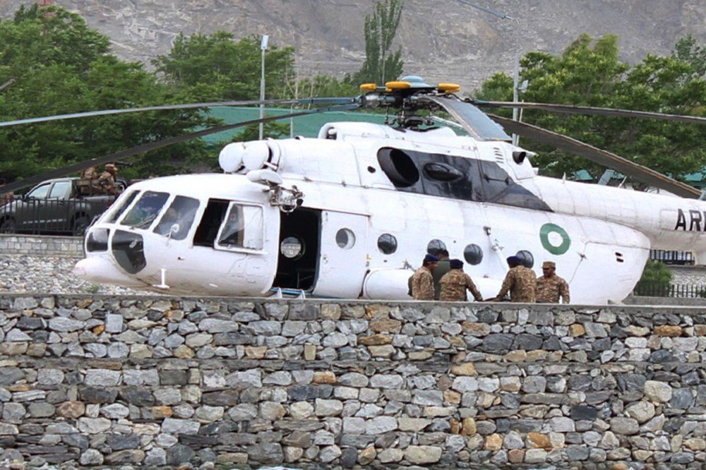 Pakistani soldiers gather beside an army helicopter at a military hospital where victims of a helicopter crash were brought for treatment in Gilgit on May 8, 2015. (Photo by Farman Karim/AFP/Getty)