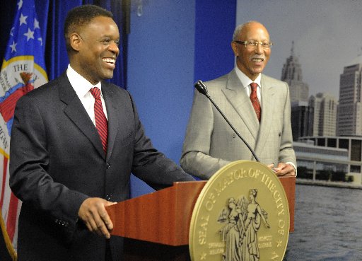 Detroit emergency financial manager Kevyn Orr, left, appears before the media later in the morning Moday, March 25, 2013, in Detroit following Mayor Dave Bing's, right, announcement of a public safety collaboration with local business leaders.  (AP...