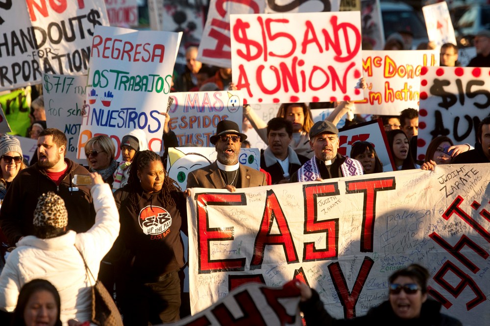 Demonstrators demanding an increase in worker wages march to a Jack in The Box fast food outlet in Oakland