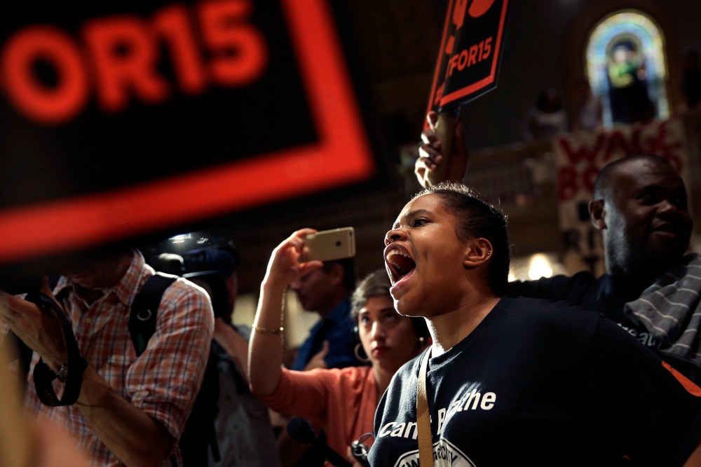 Supporters rally before a meeting of the wage board in New York, June 15, 2015. (Photo by Seth Wenig/AP)