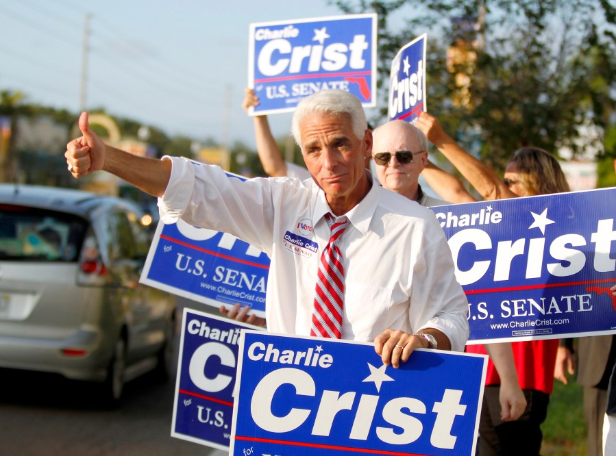 Florida Independent Senate candidate, Florida Gov. Charlie Crist, gestures toward passing motorists, Tuesday, November 2, 2010, in St. Petersburg, Florida.