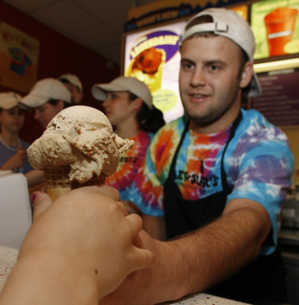 Aleck Woodmaster serves up a free ice cream cone at the Ben & Jerry's shop in Montpelier, Vt., Tuesday, April 25, 2006. The ice cream maker held its annual free cone day around the world and expects to give away more than a million cones. (AP Photo...