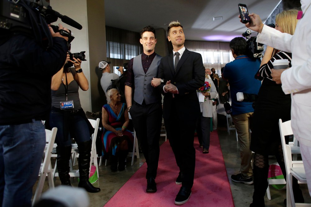 Michael Turchin, left, and Lance Bass,right, arrive for a group wedding ceremony at a hotel in honor of Florida's ruling in favor of same-sex marriage equality, Feb. 5, 2015, in Fort Lauderdale, Fla. (Photo by Lynne Sladky/AP)