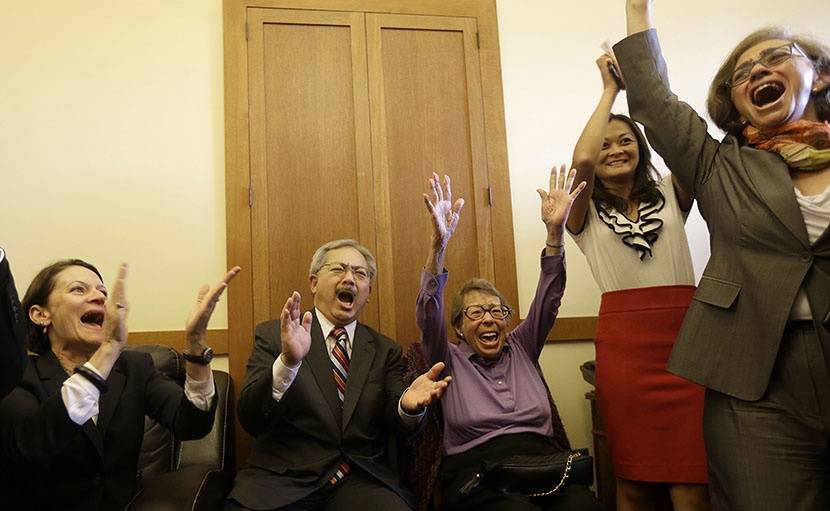 San Francisco Mayor Ed Lee, second from left, and Phyllis Lyon, center, celebrate with others after the Supreme Court cleared the way for same-sex marriage in California at the mayor's office at City Hall in San Francisco, Wednesday, June 26, 2013....