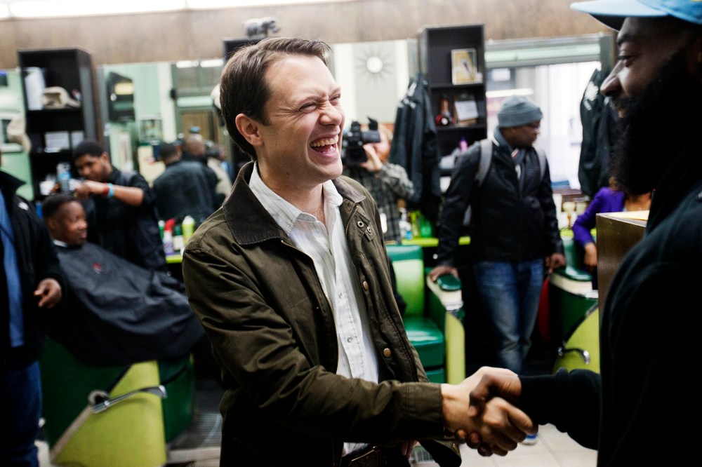 Georgia Democratic gubernatorial candidate Jason Carter, left, shakes hands with Herb Williams while greeting patrons at Vintage Barbershop in Atlanta, Ga. on Nov. 3, 2014.