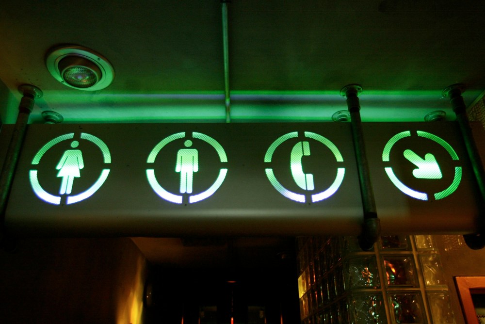 A sign points the way to the bathrooms, July 16, 2002. (Photo by Joe Raedle/Getty)