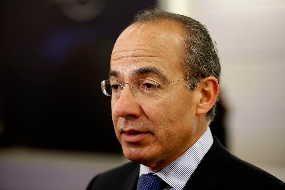 Felipe Calderon, former president of Mexico, speaks to an attendee in the halls on the opening day of the World Economic Forum (WEF) in Davos, Switzerland, Jan. 23, 2013. (Photo by Jason Alden/Bloomberg/Getty)