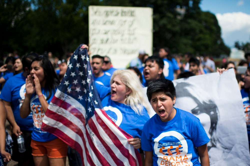 Immigration reform protesters with United We Dream chant in front of the White House to illustrate the stories of immigrant families on July 28, 2014. (Photo by Bill Clark/CQ Roll Call/Getty)