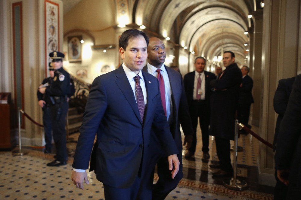 U.S. Sen. Marco Rubio and Sen. Tim Scott walk through the U.S. Capitol on Feb. 12, 2014 in Washington, DC. (Photo by Chip Somodevilla/Getty)