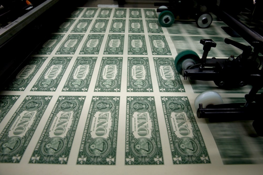 50 subject one dollar note sheets are run through an intaglio printing press before the face is printed at the U.S. Bureau of Engraving and Printing in Washington, D.C., April 14, 2015. (Photo by Andrew Harrer/Bloomberg/Getty)