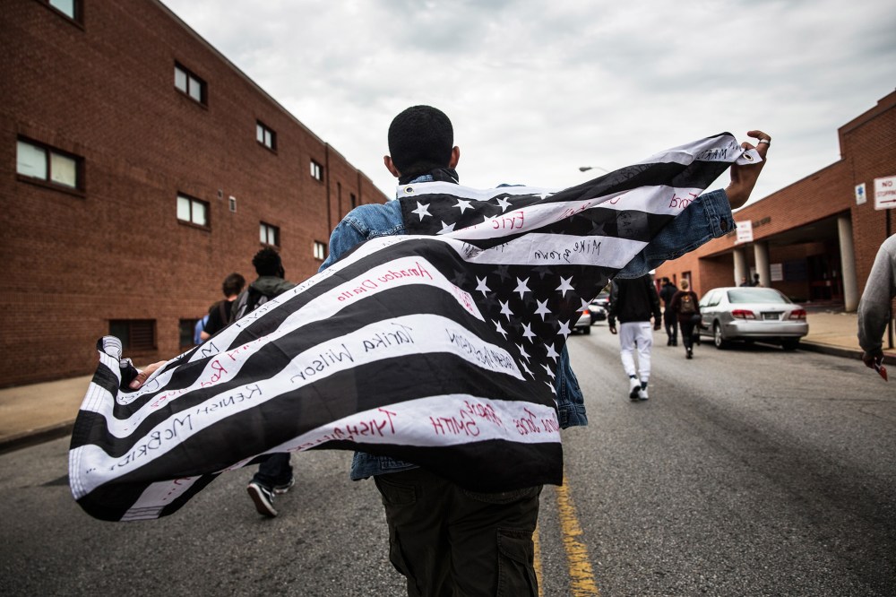 Protesters march through the streets on May 1, 2015 in Baltimore, Md., in reaction to the death of Freddie Gray. (Photo by Andrew Burton/Getty)