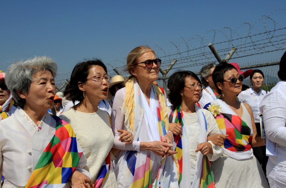 U.S. activist Gloria Steinem (C) with other activists march to the Imjingak Pavilion along the military wire fences near the border village of Panmunjom on May 24, 2015 in Paju, South Korea. (Photo by Chung Sung-Jun/Getty)