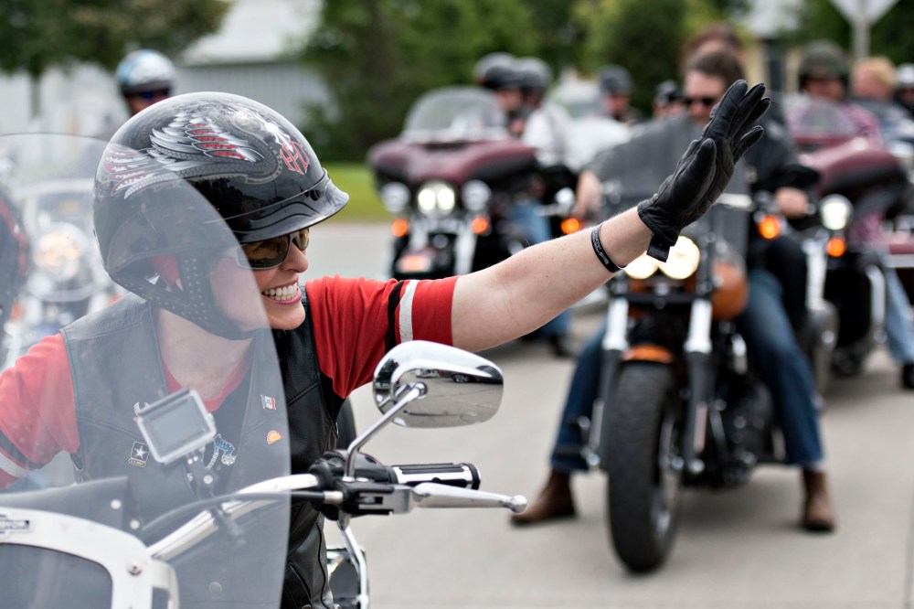 Senator Joni Ernst, a Republican from Iowa, waves to supporters as she rides the lead bike in a group motorcycle ride in Des Moines, Iowa on June 6, 2015. (Photo by Daniel Acker/Bloomberg/Getty)