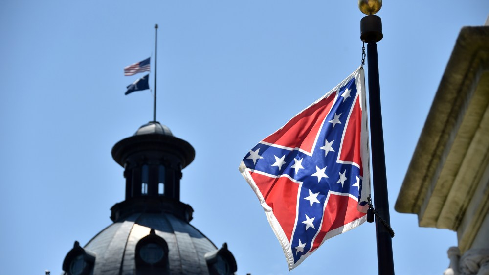 The South Carolina and American flags flying at half-staff behind the Confederate flag erected in front of the State Congress building in Columbia, S.C., June 19, 2015. (Photo by Mladen Antonov/AFP/Getty)