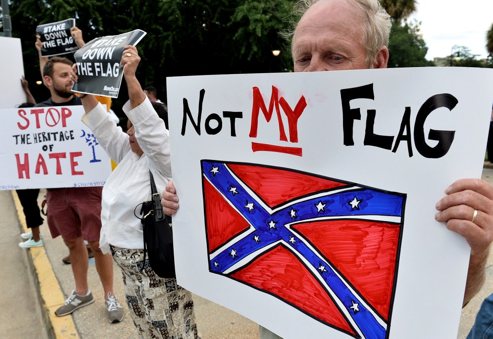 A man holds a sign up during a protest rally against the Confederate flag in Columbia, S.C., June 20, 2015. (Photo by Mladen Antonov/AFP/Getty)