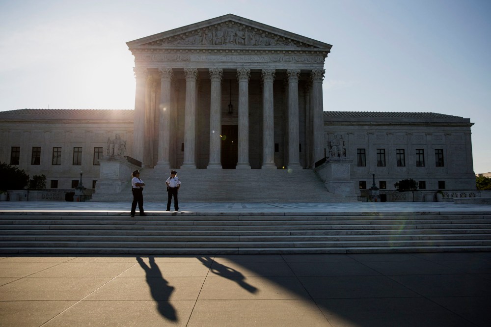 Police officers stand in front of the U.S. Supreme Court in Washington, D.C., June 22, 2015. (Photo by Drew Angerer/Bloomberg/Getty)