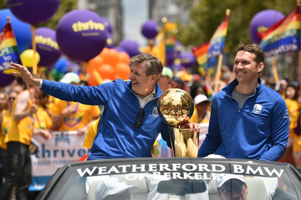 Golden State Warriors President and COO Rick Welts waves to the crowd while holding the NBA championship trophy during the annual Gay Pride Parade in San Francisco, Calif., June 28, 201. (Photo by Josh Edelson/AFP/Getty)