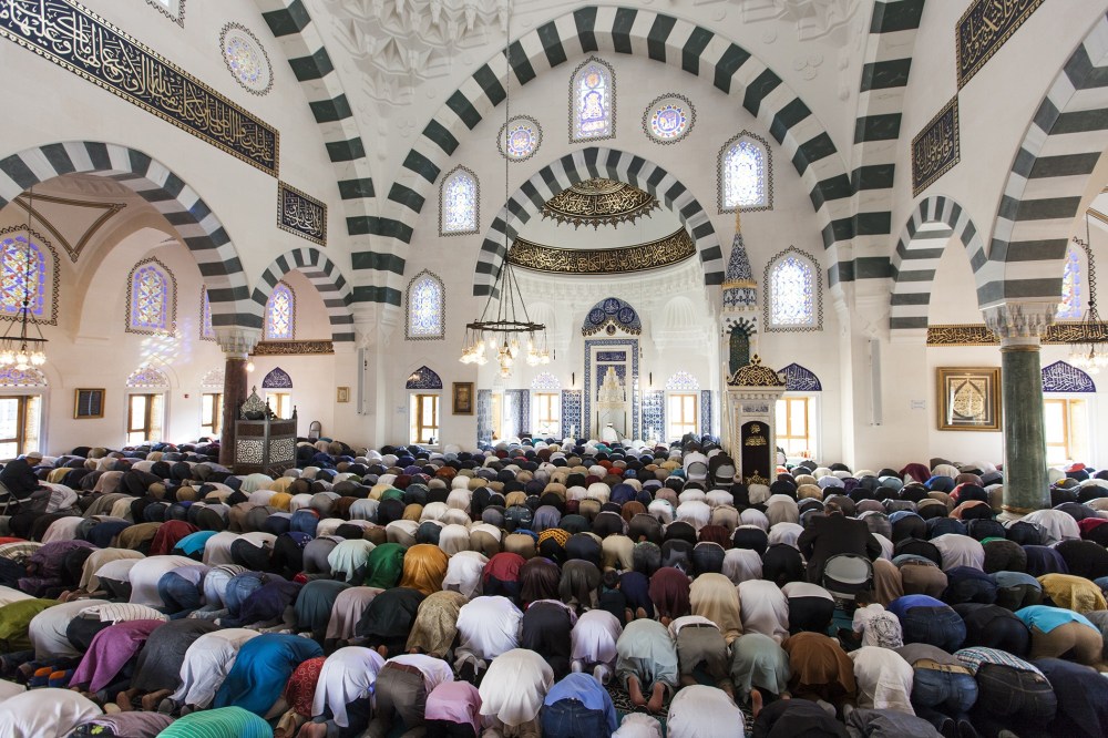Thousands of Muslims gather at the Turkish American Cultural Center Mosque to observe Eid al-Fitr during the holy month of Ramadan in Lanham, Md., July 17, 2015. (Photo by Samuel Corum/Anadolu Agency/Getty)