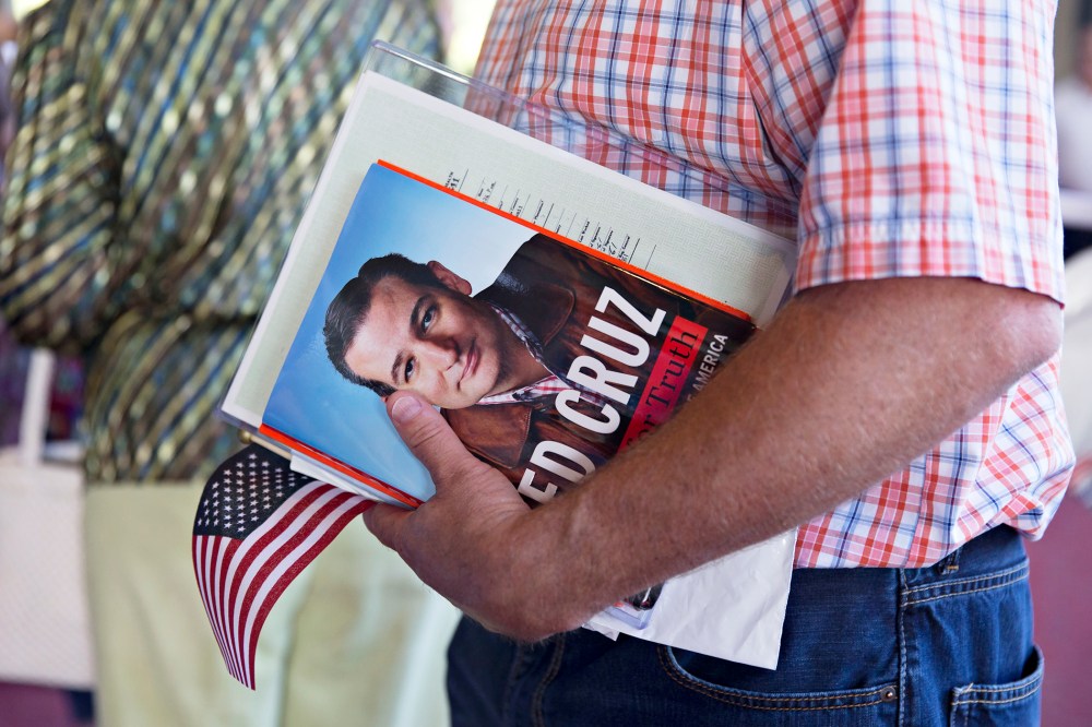 A guest holds a book by Senator Ted Cruz during The Family Leadership Summit in Ames, Iowa on July 18, 2015. (Photo by Daniel Acker/Bloomberg/Getty)