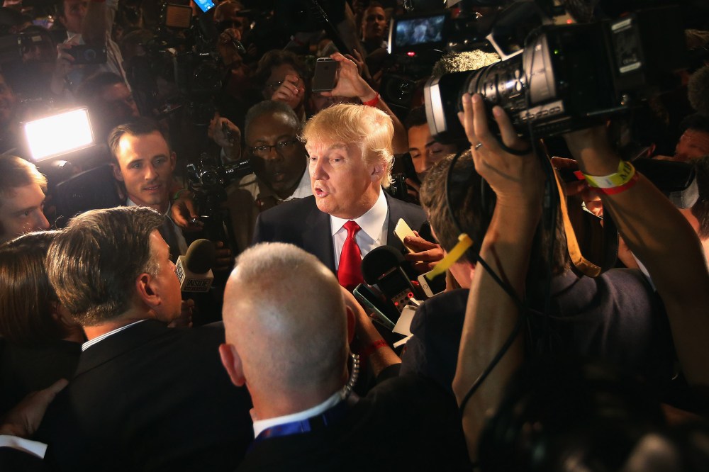 Republican presidential candidate Donald Trump talks to reporters in the 'Spin Alley' after the first prime-time presidential debate hosted by FOX News and Facebook at the Quicken Loans Arena on Aug. 6, 2015 in Cleveland, Ohio. (Photo by Scott Olson/Getty