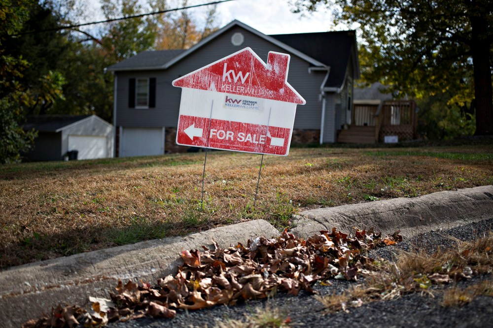 A "For Sale" sign stands outside a home in Peoria, Ill., Oct. 20, 2015. (Photo by Daniel Acker/Bloomberg/Getty)