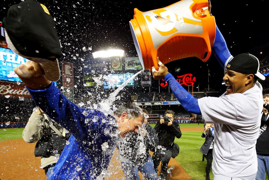 Salvador Perez #13 of the Kansas City Royals douses manager Ned Yost #3 of the Kansas City Royals after the Kansas City Royals defeat the New York Mets in Game Five of the 2015 World Series at Citi Field on Nov. 1, 2015. (Photo by Al Bello/Getty)