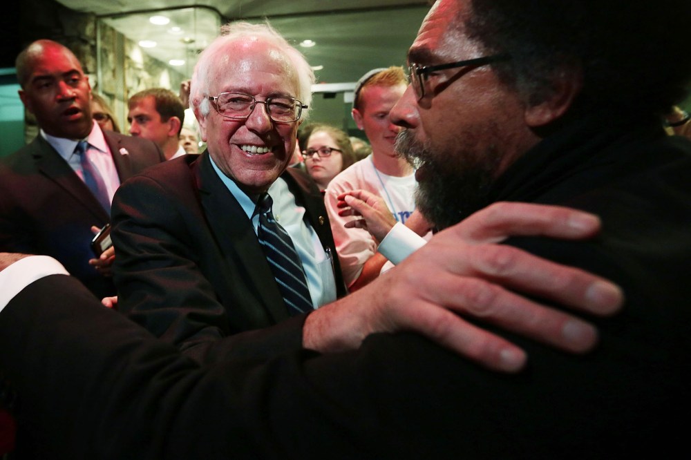 Democratic presidential candidate Sen. Bernie Sanders (I-VT) and philosopher Cornel West (R) embrace at a watch party for the second Democratic presidential debate Nov. 14, 2015 in Des Moines, Iowa. (Photo by Alex Wong/Getty)