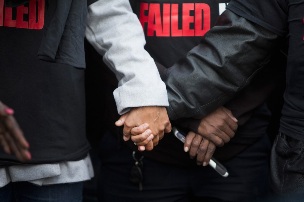Janet Cooksey is comforted during a press conference about the deaths of her son Quintonio LeGrier, and Bettie Jones before the start of a vigil on Dec. 27, 2015 in Chicago, Ill. (Photo by Scott Olson/Getty)