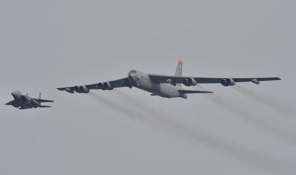 A US B-52 Stratofortress is escorted by a South Korean F-15K fighter jet as it flies over the Osan Air Base in Pyeongtaek, south of Seoul, on Jan. 10, 2016. (Photo by Jung Yeon-Je/AFP/Getty)