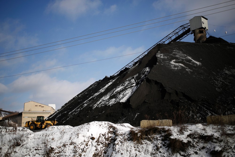 A Caterpillar Inc. front loader scoops coal from a mound at the Arch Coal Inc. Sentinel Prep Plant in Philippi, W.V., Jan. 13, 2016. (Photo by Luke Sharrett/Bloomberg/Getty)